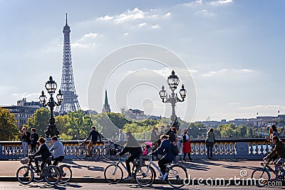 People on bicycles and pedestrians enjoying a car free day on Alexandre III bridge in Paris Editorial Stock Photo