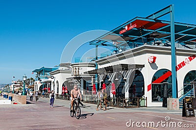 People Bike and Walk Along Mission Beach Boardwalk in San Diego Editorial Stock Photo