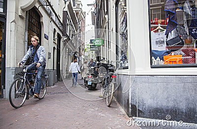 People and bikes near souvenir shop in centre of amsterdam in ho Editorial Stock Photo
