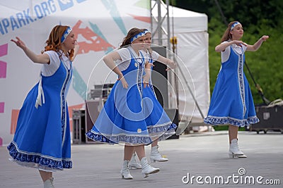 People in blue Russian national costumes dance at the International Festival â€œHave Contact Editorial Stock Photo