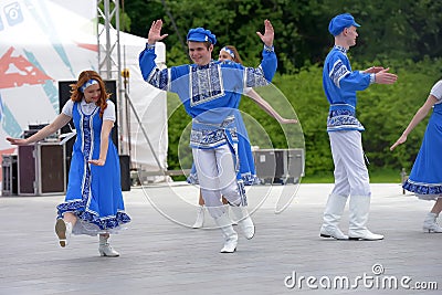 People in blue Russian national costumes dance at the International Festival â€œHave Contact Editorial Stock Photo