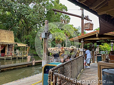 People boarding a Jungle Cruise ride boat in the Magic Kingdom at Walt Disney World Resorts in Orlando, FL Editorial Stock Photo