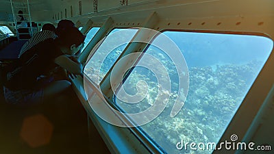 People in boat with glass bottom Stock Photo