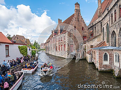 People, boats and Bakkersrei canal near Saint John`s Hospital in Bruges, Belgium Editorial Stock Photo