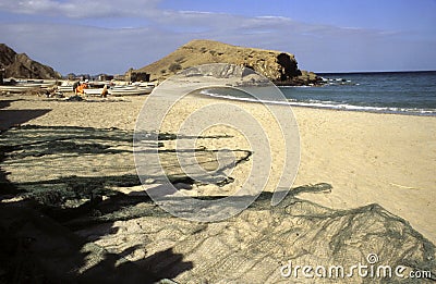 People, boats and fishermens net at the beach of Quantab, Oman Editorial Stock Photo