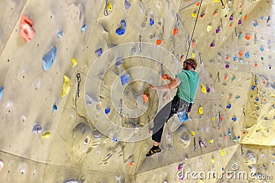 People bouldering in a climbing hall - indoor sports Stock Photo