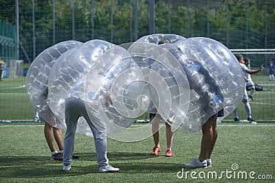 People in bubble inside putting heads together before a game Editorial Stock Photo