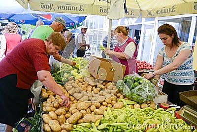 People buy fresh fruits and vegetables on a farmer market in Resen,Macedonia Editorial Stock Photo