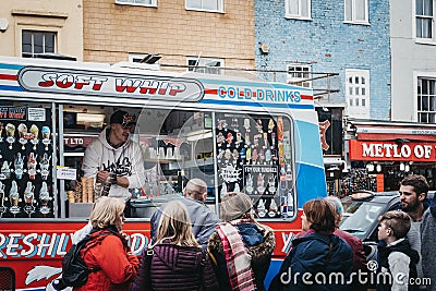 People buying ice-cream from Mr. Whippy van in Camden, London, UK Editorial Stock Photo