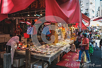 People buying and selling fish on seafood food market in HongKong Editorial Stock Photo