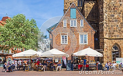 People at a cafe in front of the Liebfrauenkirche church in Bremen Editorial Stock Photo