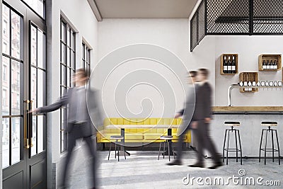 People in cafe with a yellow sofa Stock Photo