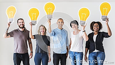 People carrying light bulb icons Stock Photo