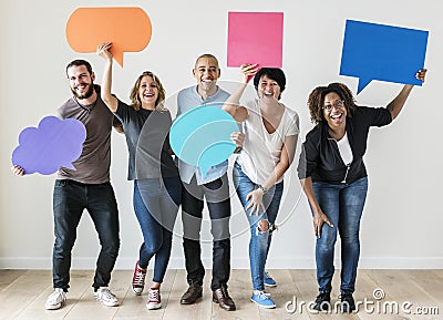 People carrying speech bubble icons Stock Photo