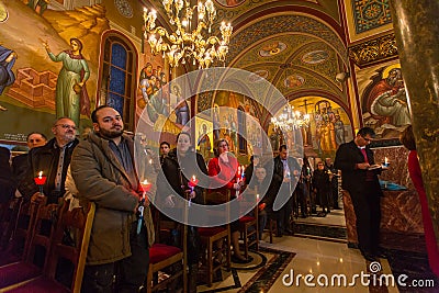 people during celebration of Orthodox Easter Holy Saturday is often the only time that the Midnight Office will be read in parish Editorial Stock Photo