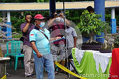 People checking and scoring bonsai on bonsai festival in Kediri Editorial Stock Photo