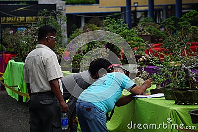 People checking and scoring bonsai on bonsai festival in Kediri Editorial Stock Photo