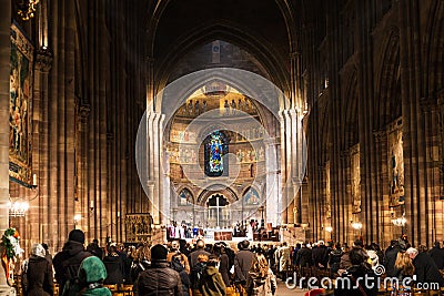 People on church service in Strasbourg Cathedral Editorial Stock Photo