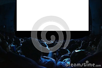 People in the cinema watching a movie. Blank empty white screen. Leisure entertainment concept Stock Photo