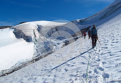 People climbers, climbing snow summit, rocky mountain peaks and glacier in Norway Stock Photo