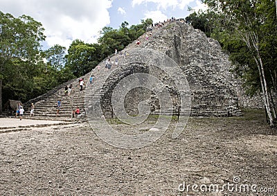 People climbing up an down the Nohoch Mul Pyramid in the Coba ruins Editorial Stock Photo