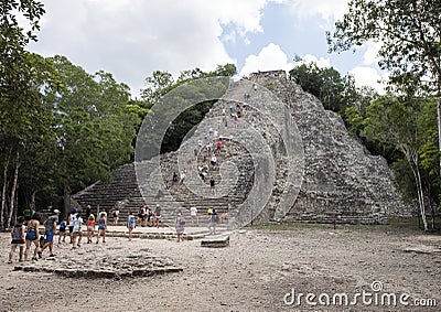 People climbing up an down the Nohoch Mul Pyramid in the Coba ruins Editorial Stock Photo