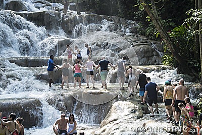 People climbing up Dunn`s River Falls, Jamaica Editorial Stock Photo