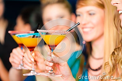 People in club or bar drinking cocktails Stock Photo