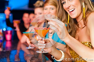People in club or bar drinking cocktails Stock Photo