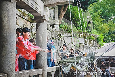 People collecting water from the Otowa-no-taki waterfall at Kiyomizu temple Editorial Stock Photo