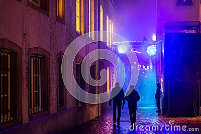 People on colorful illuminated street Stock Photo