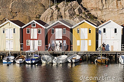 People and colorful wooden fishing sheds Editorial Stock Photo