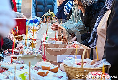 People come to church consecrate Easter cakes and eggs, lit church candles Editorial Stock Photo