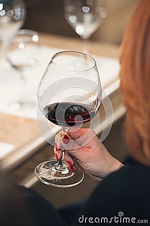 People consider the color of the wine and try how it smells in different glasses Stock Photo