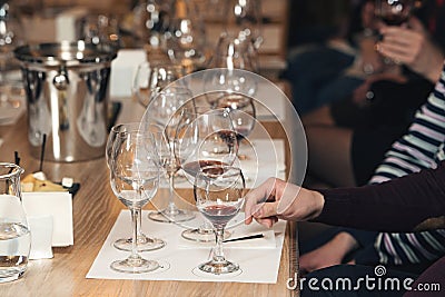 People consider the color of the wine and try how it smells in different glasses Stock Photo