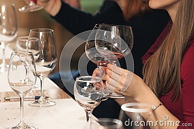 People consider the color of the wine and try how it smells in different glasses Stock Photo