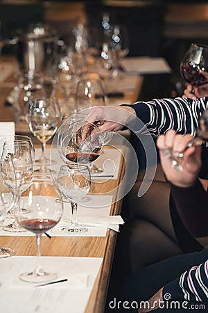 People consider the color of the wine and try how it smells in different glasses Stock Photo