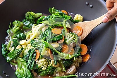 People cooking healthy vegetarian chinese food capcay Stock Photo