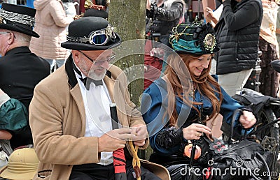 People in costume sat on bench at the annual hebden bridge steampunk weekend Editorial Stock Photo