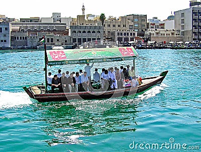 People cross the Dubai Creek between the districts of Deira and Bur Dubai aboard a traditional Abra water taxi Editorial Stock Photo