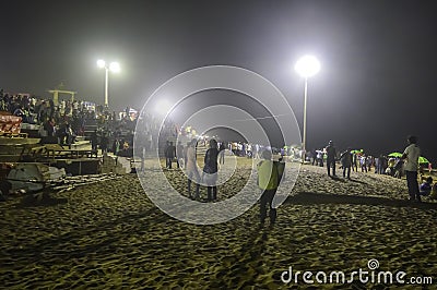 People crowd at night after sunset in a beach party in summer vacation - Goa India Editorial Stock Photo