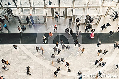 People crowd walking in the business centre and shopping mall entrance. View from the top. Stock Photo