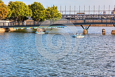 People cruising on pedalo boat over the St. Lawrence river in old port, Montreal, Quebec, Canada Editorial Stock Photo