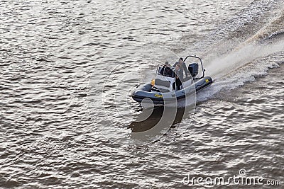 People cruising the Thames by motorboat, London, UK Editorial Stock Photo