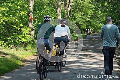 People cycling, Jogging and walking on the bikeway in the afternoon , Lexington, MA. USA. May 21, 2023 Editorial Stock Photo