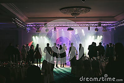 People dancing in the neon lights during the wedding party Editorial Stock Photo