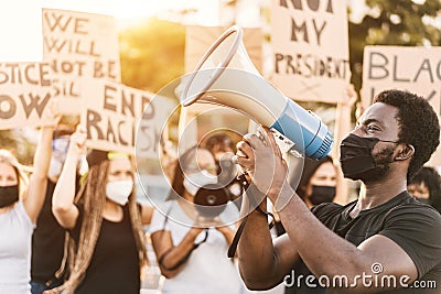 People from different culture and races protest on the street for equal rights - Demonstrators wearing face masks during black Stock Photo