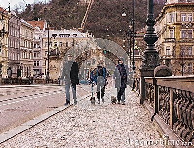 people with dogs on the tourist streets of Prague Editorial Stock Photo