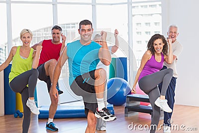 People doing power fitness exercise at yoga class Stock Photo