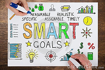 People Drawing Smart Goals Concept On Paper Stock Photo